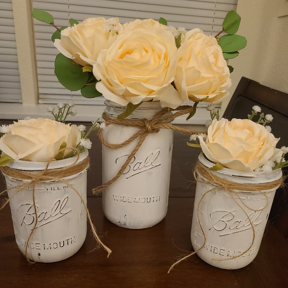 Set of three painted mason jars with flowers